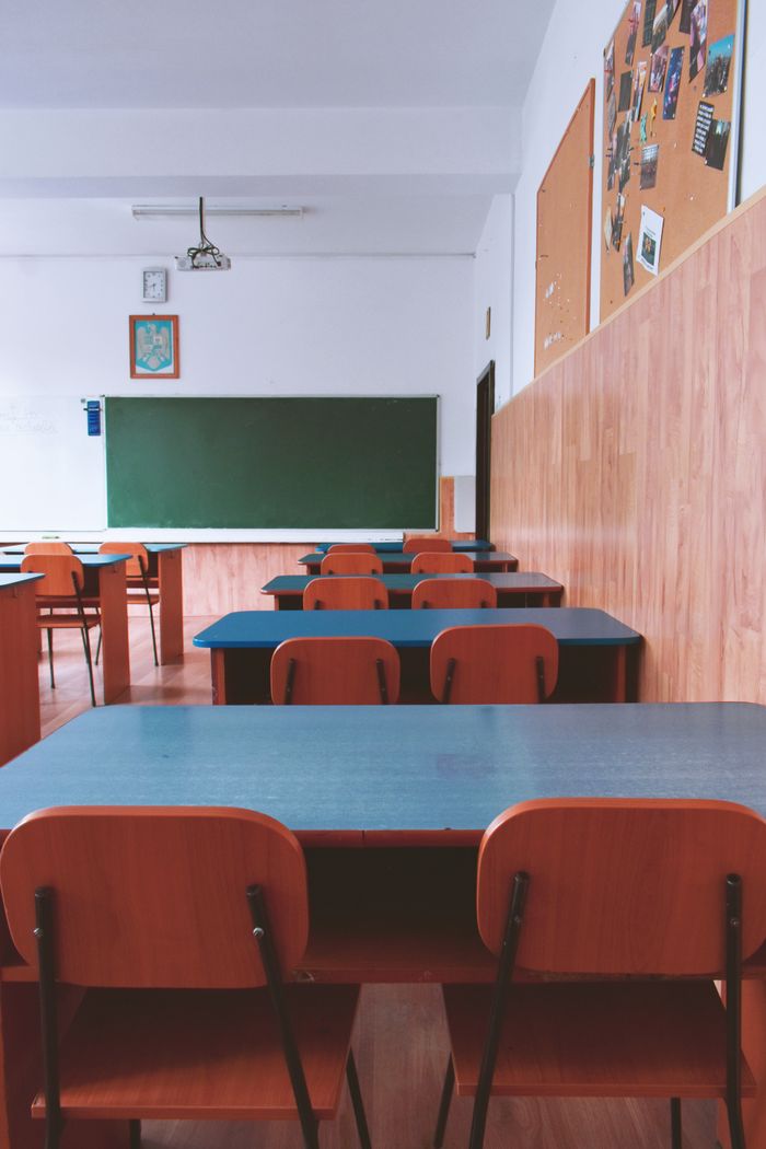 Crafting Captivating Headlines: Your awesome post title goes here A tranquil empty classroom with wooden furniture and a green chalkboard, perfect for educational themes.